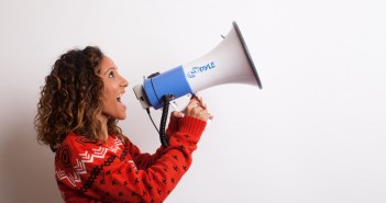 Photo of a woman shouting into a megaphone