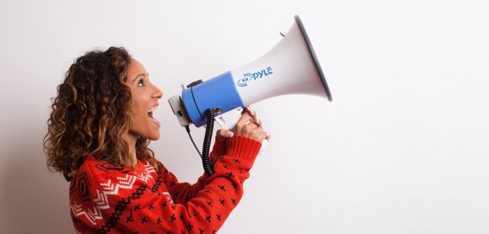 Photo of a woman shouting into a megaphone