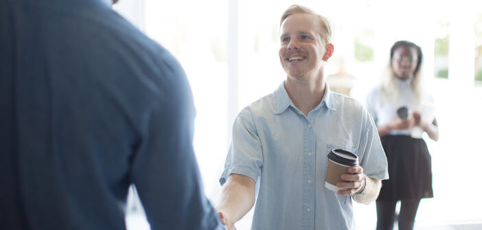 Church greeter shaking hands with a visitor