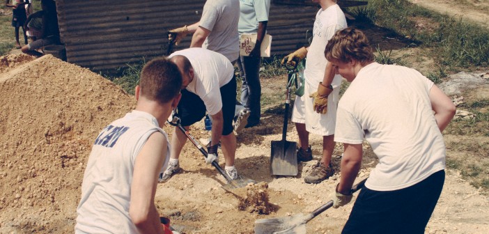 Stock photo of a group of people working on a community farm