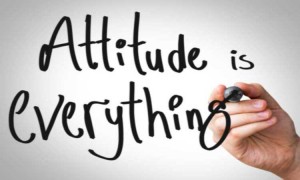 Stock photo of someone writing "Attitude is everything" on a whiteboard