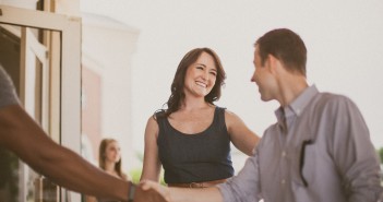 People shaking hands outside a church entrance