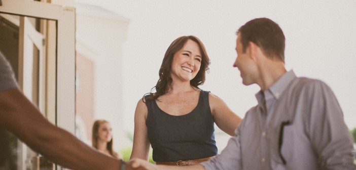 People shaking hands outside a church entrance