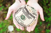 Photo of a ball of money cupped in a person's hands