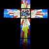 stock image of stained glass cross with dove