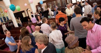 Stock photo of a diverse group of people greeting each other during worship