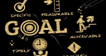 Clip art of a blackboard with words pertaining to "GOALS" written on it