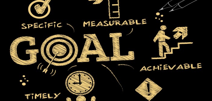 Clip art of a blackboard with words pertaining to "GOALS" written on it