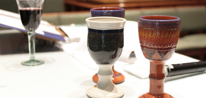 Photo of several cups to be used in a communion service
