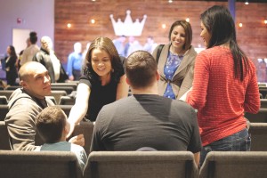 Stock photo of a group of people of mixed genders and races and ages in fellowship with one another