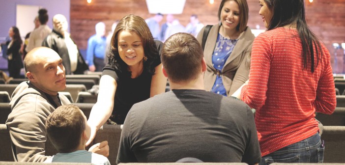 Stock photo of a group of people of mixed genders and races and ages in fellowship with one another