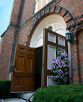 Picture of a brick church with open doors