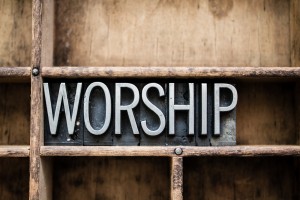 The word "WORSHIP" written in vintage metal letterpress type