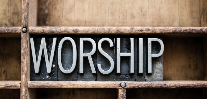 The word "WORSHIP" written in vintage metal letterpress type