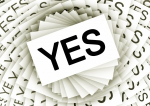 Stock photo of a myriad of white business cards with "YES" printed on them in bold, black letters