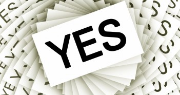 Stock photo of a myriad of white business cards with "YES" printed on them in bold, black letters