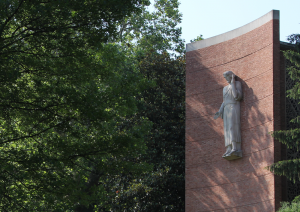 Image of Jesus statue, a chapel, and trees