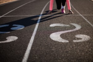 Photo of a runner in the starting blocks of a racetrack