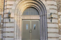 Photo of an arched doorway of a stone seminary building