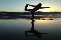 The Myth of Balance Silhouette of a woman striking a balanced yoga pose on a beach