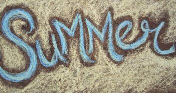 Sidewalk chalk drawing of the word SUMMER
