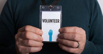 Man holding volunteer card