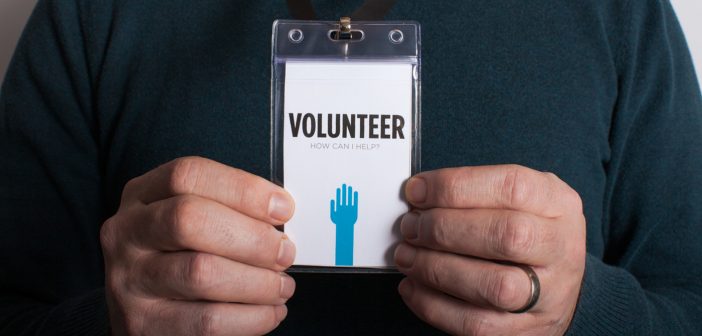 Man holding volunteer card