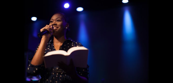 Photo of a young female pastor preaching