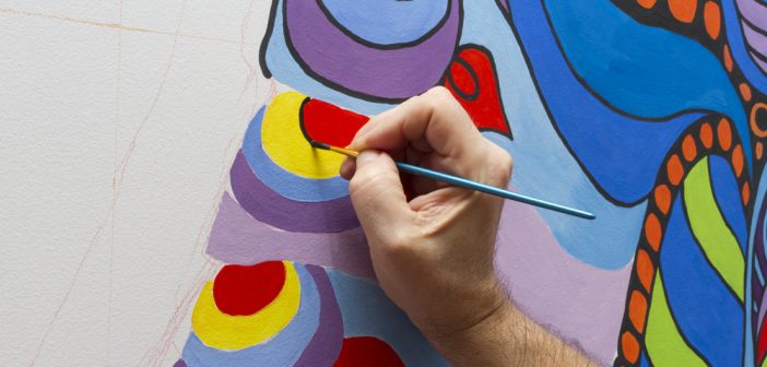 Photograph of someone painting a mural