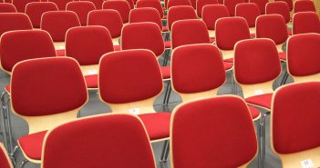 A bunch of red chairs set up in an overflow room on Easter Sunday