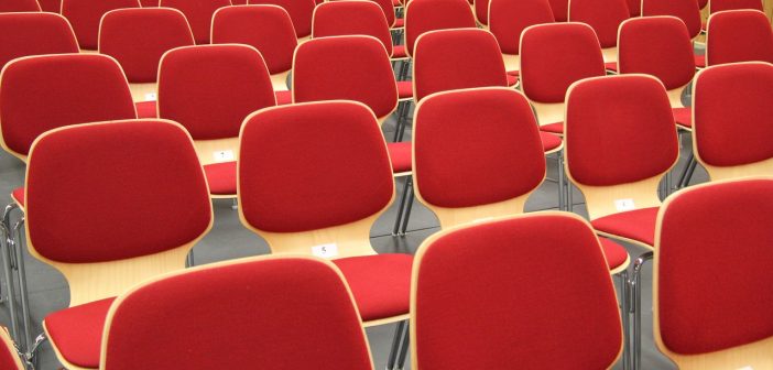 A bunch of red chairs set up in an overflow room on Easter Sunday