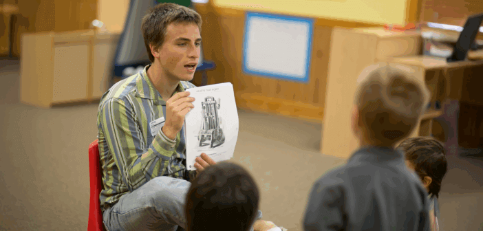 Building Congregational Engagement in a Church-School Partnership Teacher showing a photo in a book to students in a classroom