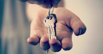 A hand holding a set of keys embarking on one of life's transitions