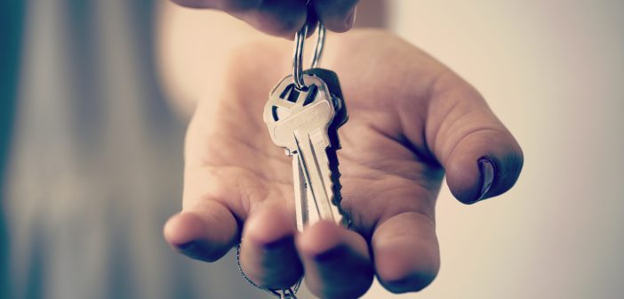 A hand holding a set of keys embarking on one of life's transitions