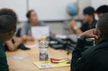 7 Strategies to Master Meetings Photo of people meeting around a conference table