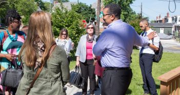 Photo of church members standing outside chatting with people from their neighborhood