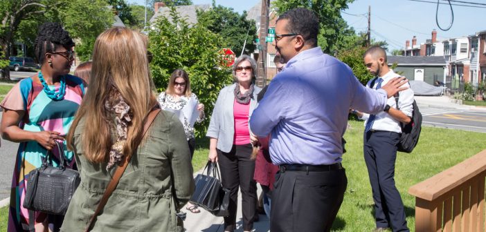 Photo of church members standing outside chatting with people from their neighborhood