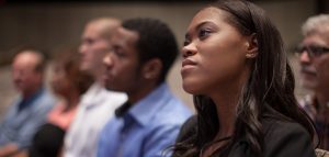 Photo of worshipers in pews listening with rapt attention