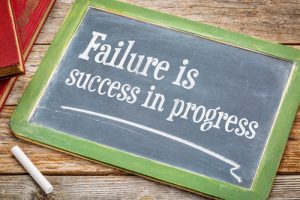Stock photo of chalkboard with Failure is Success in Progress written on it