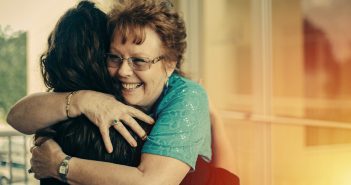 Photo of two parishioners sharing a warm hug