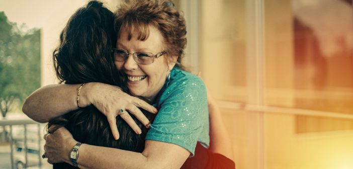 Photo of two parishioners sharing a warm hug