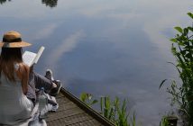 Should you Take an Electronic Sabbath? Photo of a person reading a book on a lakeside dock