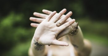 Photo of outstretched hands signaling NO