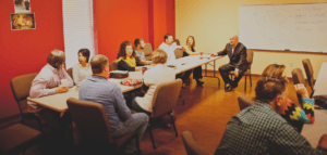 People in discussion at tables in a Sunday school class