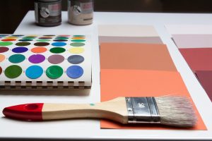 Picture of a paint brush and paint samples.