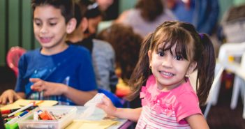 Photo of happy children coloring