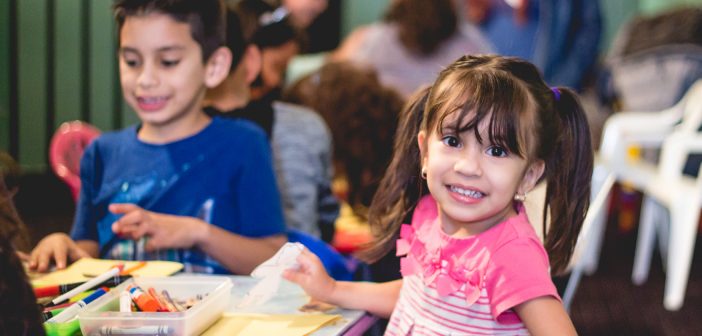 Photo of happy children coloring