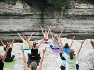 Photo of women participating in an outdoor yoga class.