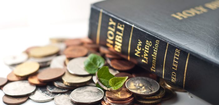 Photo of a Bible and a pile of coins