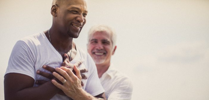 Photo of a pastor baptizing a smiling person in a lake